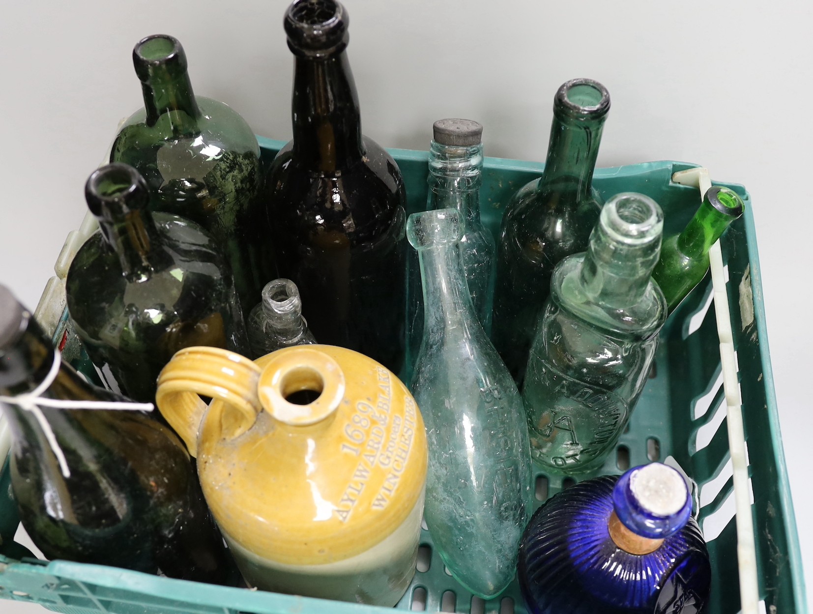 A Hardens 'Hand Grenade' fire extinguisher, an 18th century apothecary's bottle and various small coloured glass potion and ink bottles together with a collection of old wine and mineral water bottles